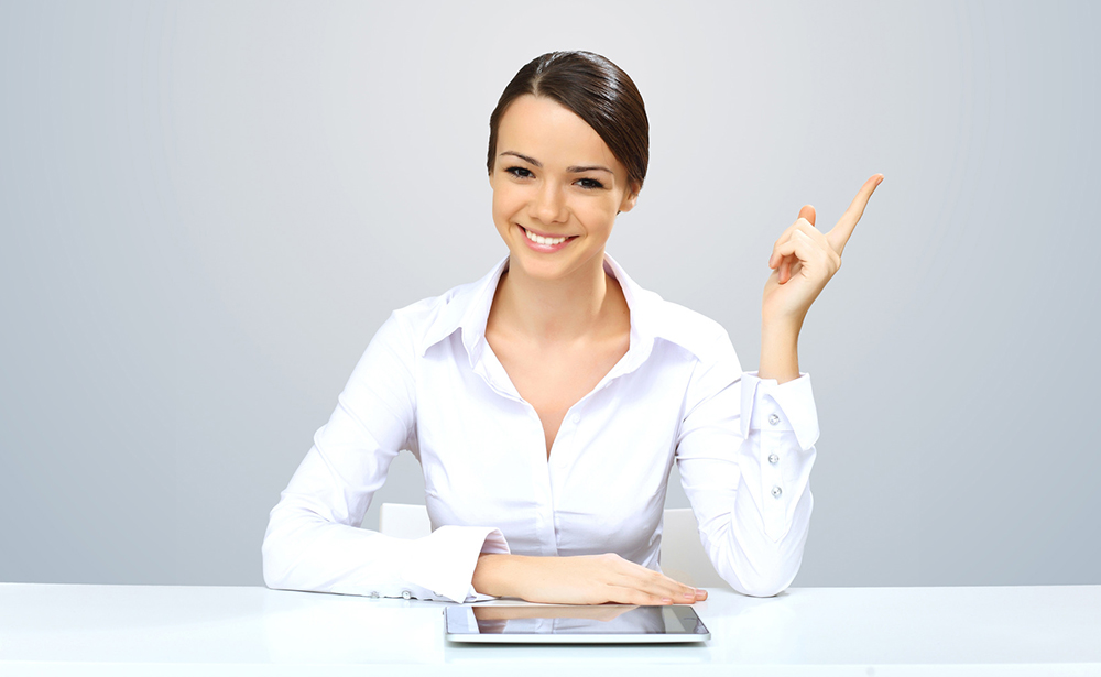 Young beautiful woman in business wear at work